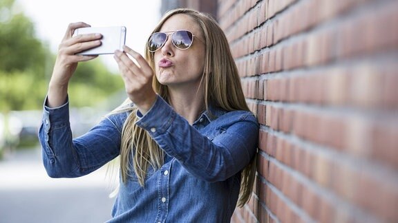 Junge Frau macht ein Selfie von sich.